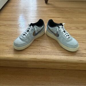 Custom Nike Air Force One. Size 9.5. Light blue canvas with designer “swoosh”.